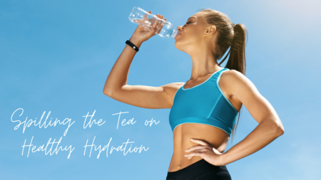 woman wearing a blue sports bra drinking water